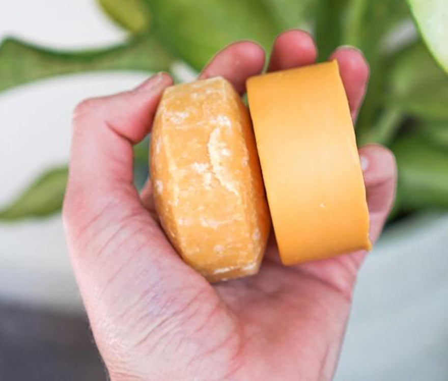 a person holding a pair of shampoo bars