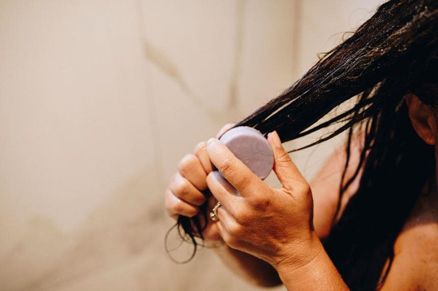 applying conditioner bar to hair