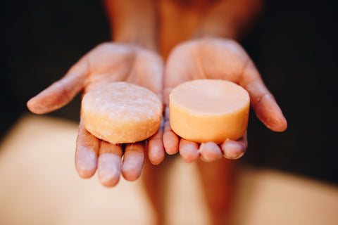 hand holding natural shampoo bar