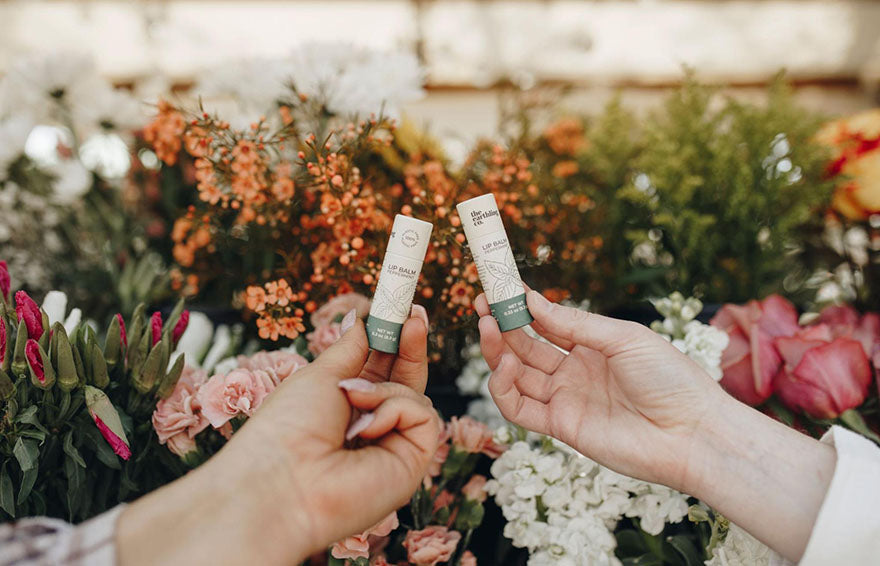 holding up lip balm pair