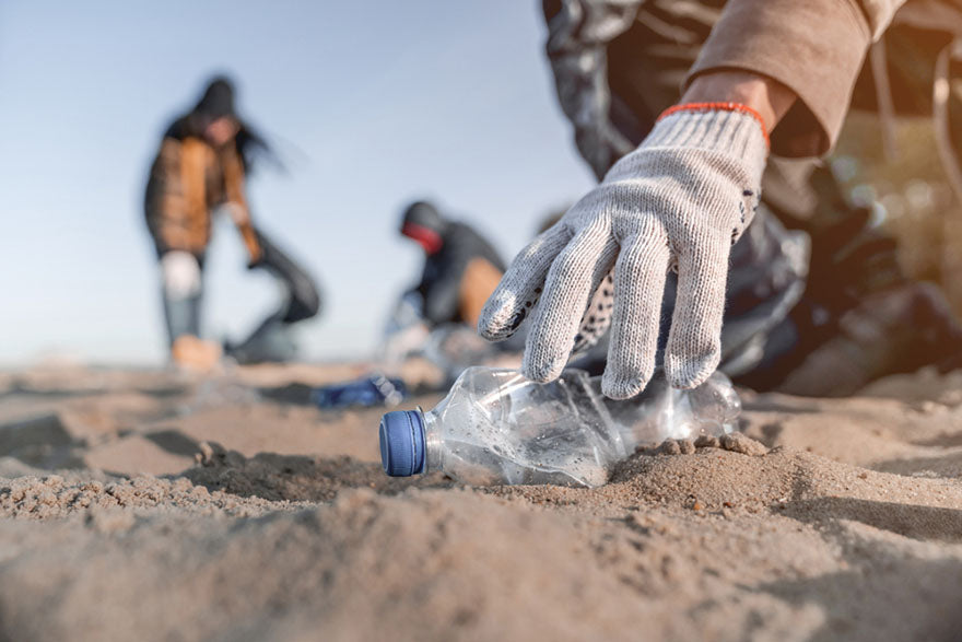 man collecting trash on beach