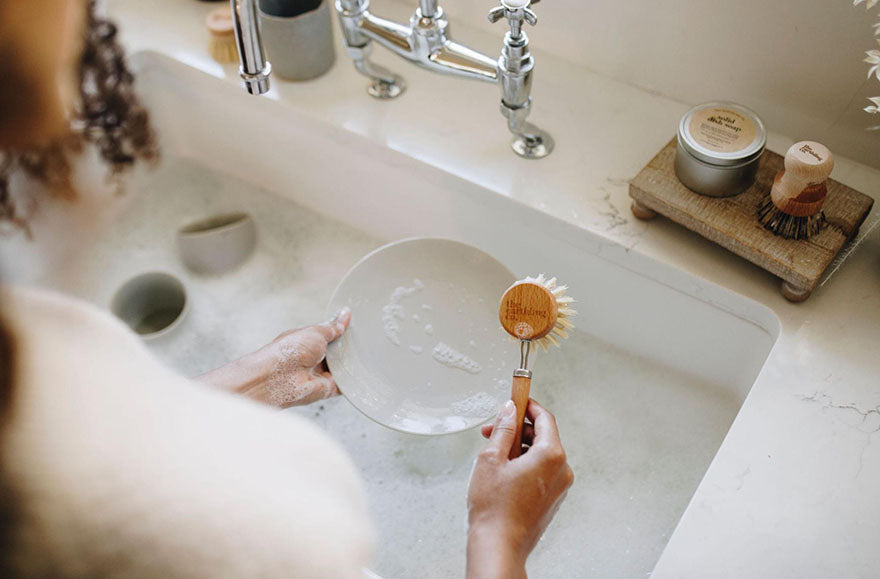 washing dishes wooden brush