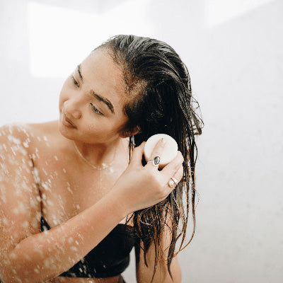 woman in shower using conditioner bar